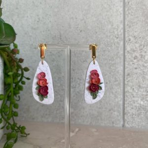 floral earrings on organic shaped white background
