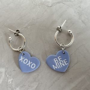 blue heart earrings reading "be mine" and "xoxo"